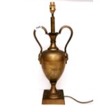 An interesting early to mid 20th Century brass table lamp with 'green man style' handles, H. 54cm.