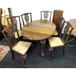 A 1920's mahogany ball and claw oval extending dining table with a set of six ball and claw mahogany