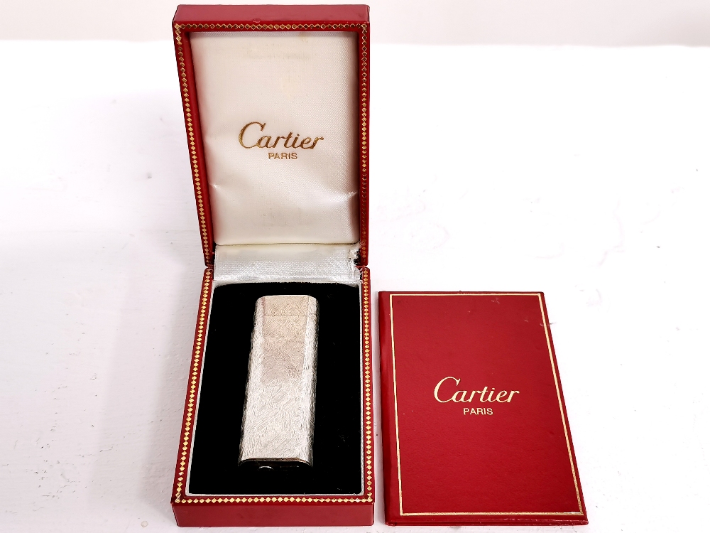 A boxed Cartier silver lighter.