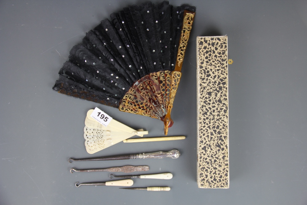 A vintage cased Celluloid and lace fan with a further Celluloid fan and other items.