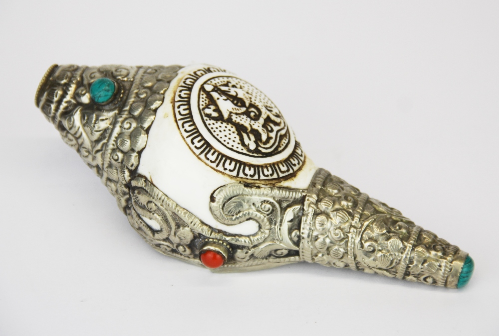 A Tibetan white metal mounted conch shell horn, L. 15cm.