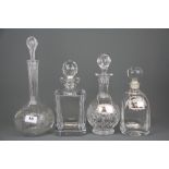 Three cut crystal decanters and a further glass decanter together with two hallmarked silver labels,