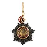 Islamic interest. A yellow and white metal (tested gold and silver) enamelled pendant decorated with