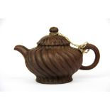 A Chinese Yixing terracotta teapot, H. 11cm, spout to handle 18cm.