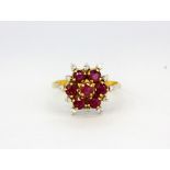 An 18ct yellow gold cluster ring set with rubies and diamonds, (N).