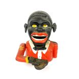 A reproduction cast iron black boy money box, H 15cm.