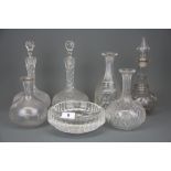 A group of six cut glass decanters and a Waterford crystal ashtray.