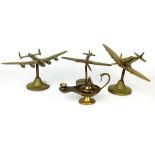 Three brass models of WWII aircraft and a brass Aladdin's lamp, tallest 14cm.