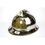 A vintage steel and brass fireman's helmet.