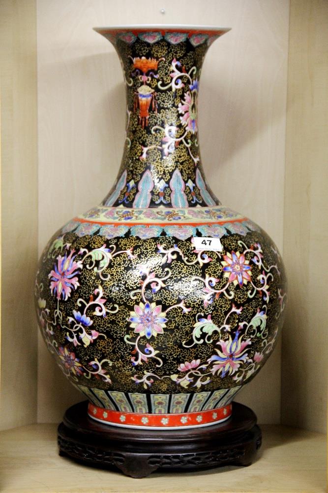 An impressive 19th / early 20th century Chinese porcelain vase with famille noire decoration and a