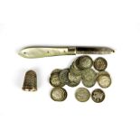 A silver fruit knife, thimble and thrupenny pieces.