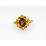 A 9ct yellow gold cluster ring set with smokey quartz and citrines, (N).