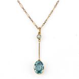 A yellow metal (tested 9ct gold) pendant and chain set with oval cut blue stones, L. 3.8cm.