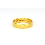 A 22ct yellow gold wedding band, (M).