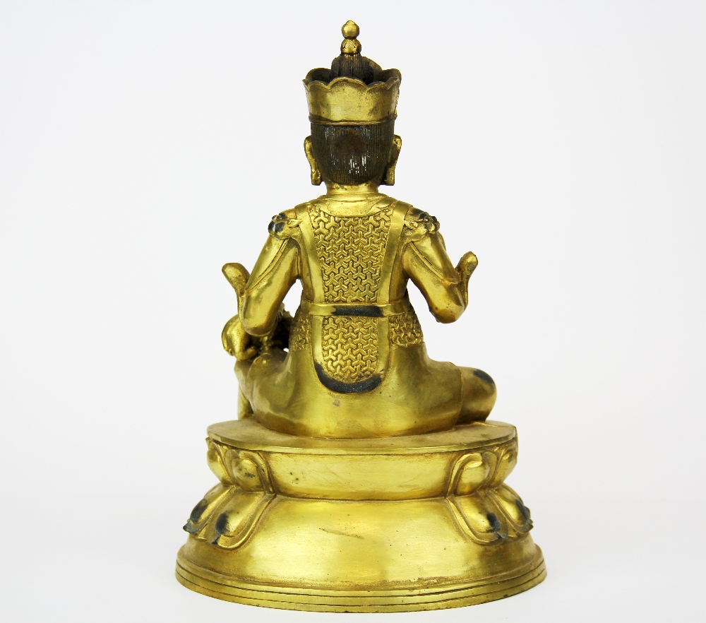 A Tibetan gilt bronze figure of a seated Buddhist Deity, H. 26cm. - Bild 2 aus 3
