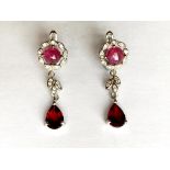 A pair 925 silver drop earrings set with cabochon cut rubies and pear cut garnets, L. 3.2cm.