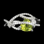 A 925 siver ring set with a trillion cut peridot and white stones, (R).