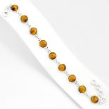 A 925 silver bracelet set with cabochon cut tiger's eye, L. 18cm.