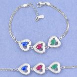 A 925 silver heart shaped bracelet set with oval cut emerald, sapphire and ruby and white stones, L.