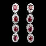 A pair of 925 silver drop earrings set with oval cut rubies surrounded by white stones, L. 3.7cm.