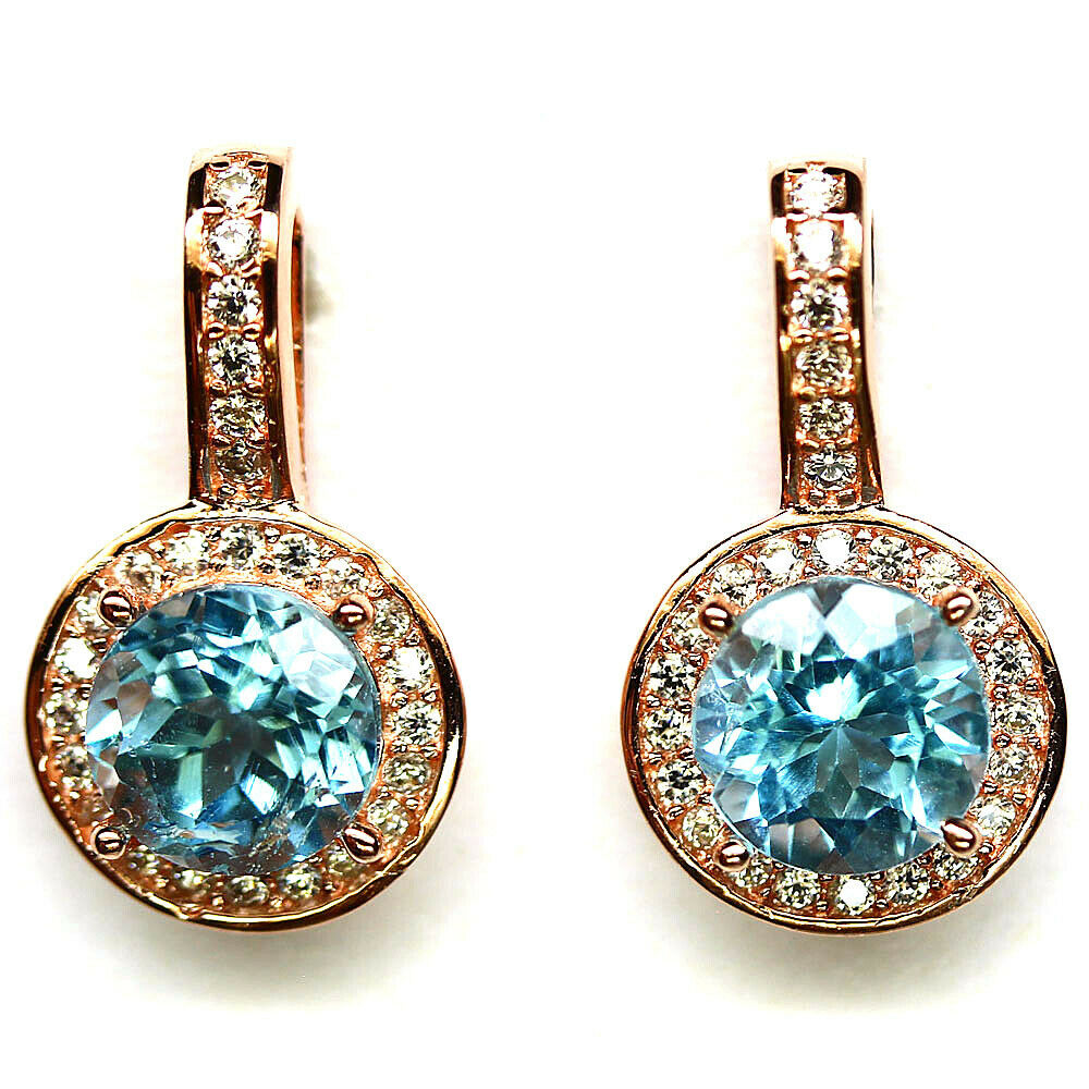 A pair of 925 silver rose gold gilt earrings set with sky blue topaz and white stones, L. 2cm.