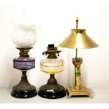 Two Victorian oil lamps converted for use with electricity together with a brass desk lamp.