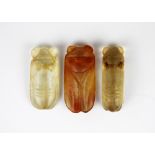 A group of three carved rock crystal insect netsuke, largest 6.5cm.