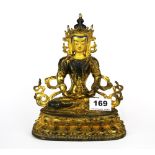 A Tibetan temple quality gilt bronze figure of a seated Tara with hand painted face, H. 22cm.