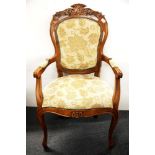 An upholstered carved armchair.