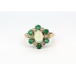 A 9ct yellow gold cluster ring set with opal, emerald and diamonds, (J).