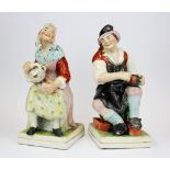A pair of 19th Century Staffordshire figures of The Cobbler and his wife, H. 32cm.
