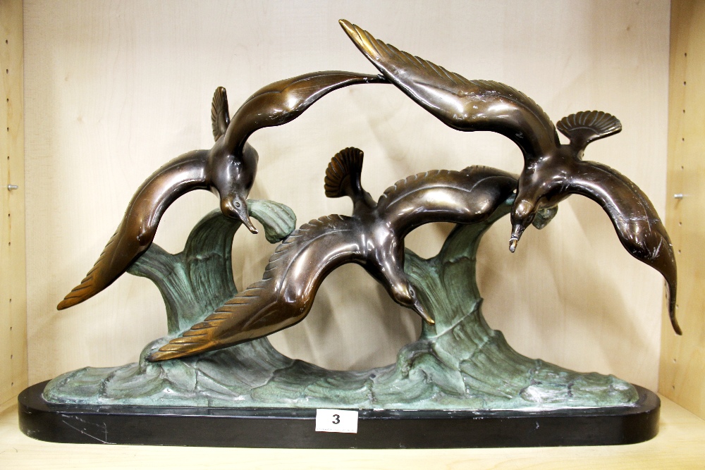 An Art Deco bronze figure of three seagulls on a black slate base (repaired) , L. 67cm. H. 41cm.