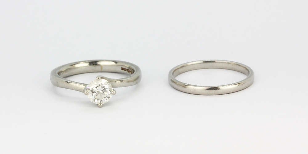 A 950 platinum solitaire ring set with a brilliant cut diamond, together with a matching 950