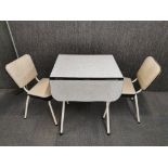 A 1960's Formica dropleaf kitchen table and two matching chairs table size 68 x 55cm. opening to