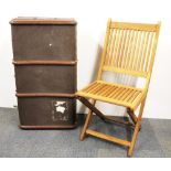 A vintage cabin trunk and folding chair.