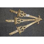 Three impressive hammered brass door hinges, L. 43cm.