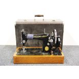 A cased Singer hand sewing machine.