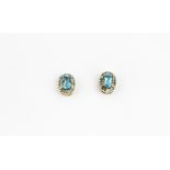 A pair of 9ct yellow gold blue topaz and diamond set stud earrings, L. 0.6cm.