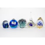 A group of five glass paper weights, tallest 15cm.