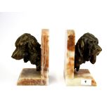 A pair of Art Deco spelter and alabaster book ends, H. 19cm.