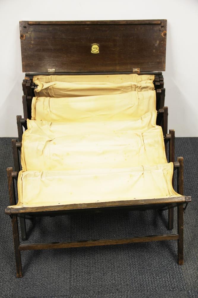 A First World War period oak fold out bed, W. 78cm. together with a brass fire screen. - Image 2 of 3