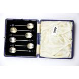 A cased set of hallmarked silver coffee bean spoons.