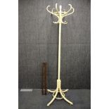 A painted bentwood hat stand together with a wall mounted coat rack.