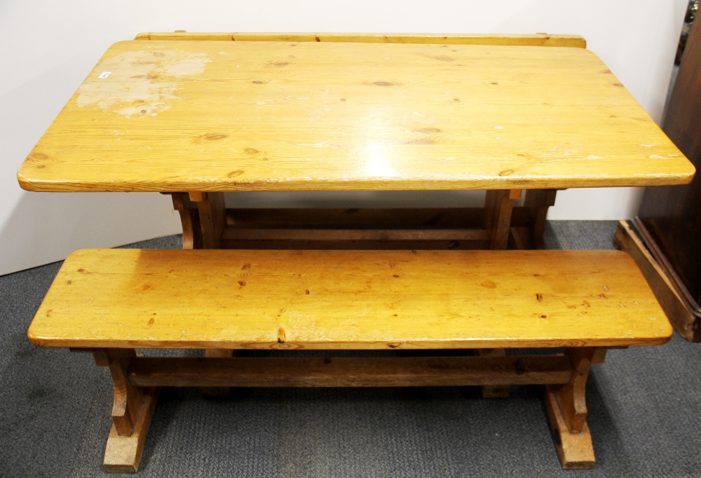 A vintage pine kitchen table and two benches, L. 137cm. W. 76cm.