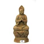 A Chinese carved wooden figure of a seated Buddha, H. 34cm.