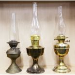 Three brass oil lamps.