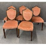 Five upholstered shield back chairs.