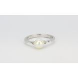 A 9ct white gold ring set with a cultured pearl and diamonds, (N).