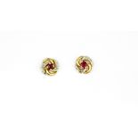 A pair of 9ct yellow gold ruby and diamond set stud earrings, Dia. 0.8cm, (with replaced