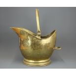 A Maple & Co hammered brass coal bucket.
